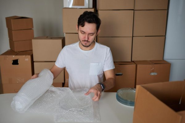 man-collects-plates-boxes-moving_152904-25727