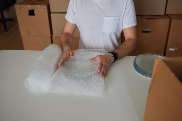man-collects-plates-boxes-moving_152904-25728