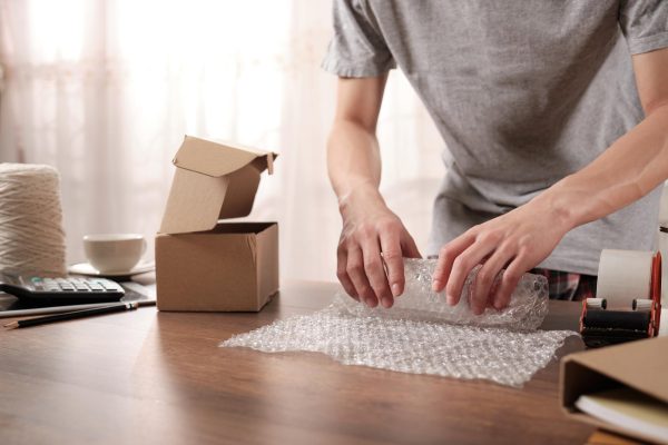 midsection-businessman-packing-table_1048944-23200038
