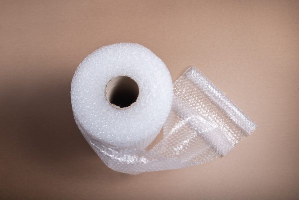 roll-bubble-film-brown-cardboard-background_181654-3176